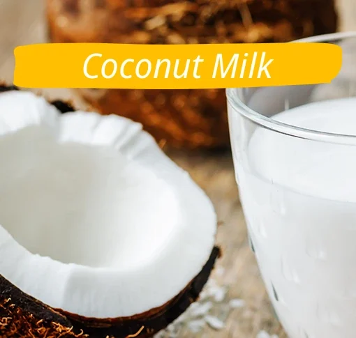 a half of coconut and coconut milk in a glas